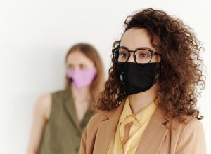 woman wearing glasses and protective mask on focus